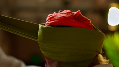 Studio-Shot-Of-Senior-Sikh-Man-With-Beard-Tying-Fabric-For-Turban-Against-Plain-Background-Shot-In-Real-Time-3